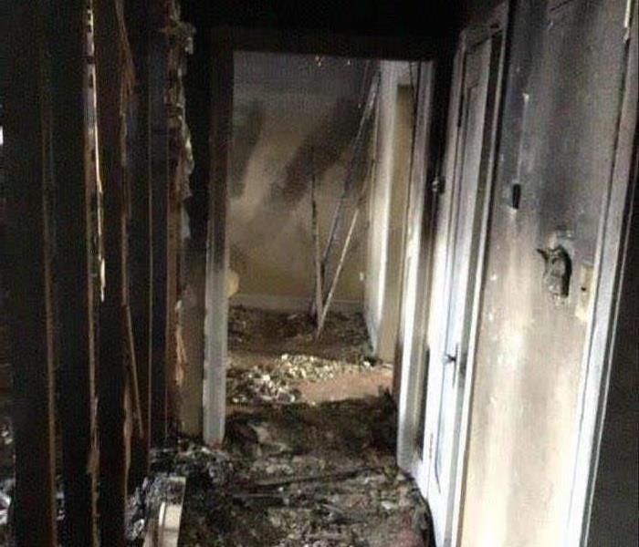 apartment hallway blackened with severe fire damage