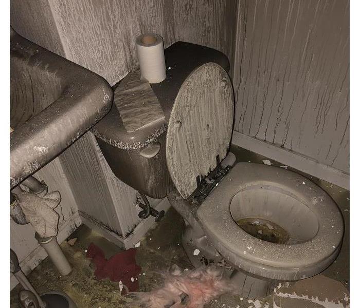 Bathroom blackened by soot and debris after fire 