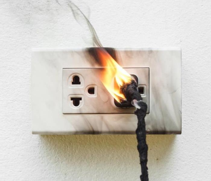 Chord plugged into outlet on fire